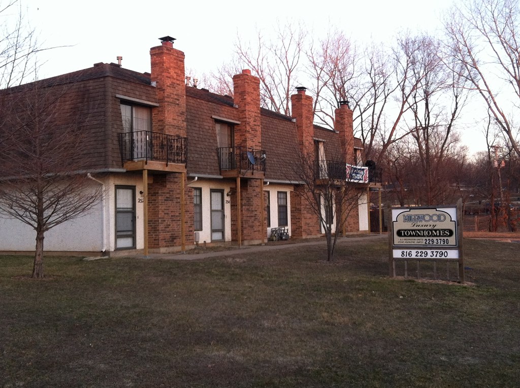 a large brick building with a sign in front of it