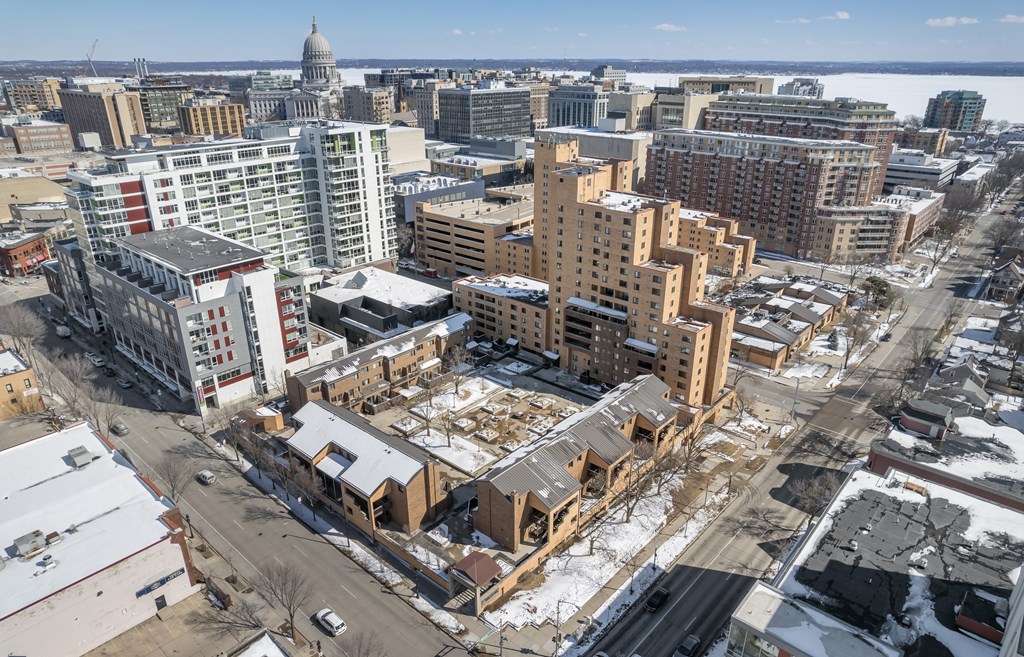 an aerial view of a city with buildings under construction in the snow