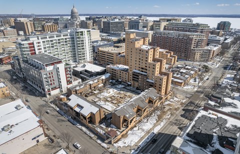 an aerial view of a city with buildings under construction in the snow