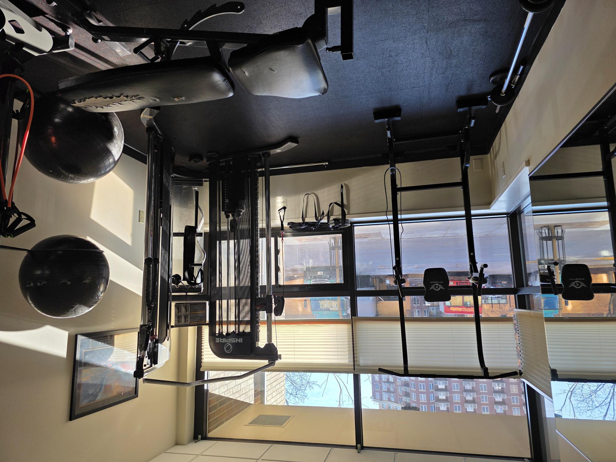 A gym with a view of the city outside the window.
