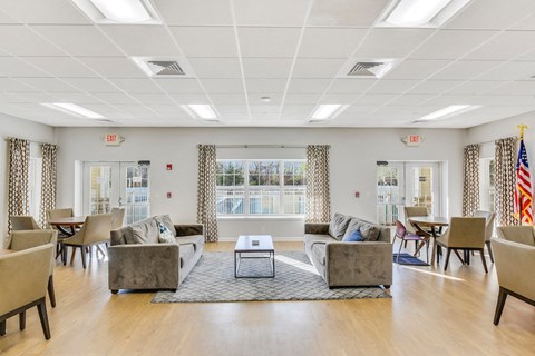 Room with sofas and dining tables at Eagle View Court 55+ Community Apartments, Middle Island