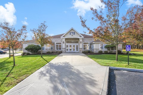 Building entrance with accessible parking at Eagle View Court 55+ Community Apartments, Middle Island, NY 11953