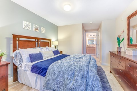 A bedroom with a bed, dresser, and mirror at The Lodge at Peasley Canyon in Federal Way, 98001