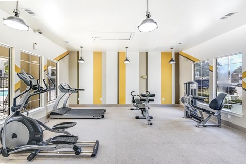 A gym with treadmills, elliptical machines, and other exercise equipment at Acclaim at South Congress, Austin, 78704