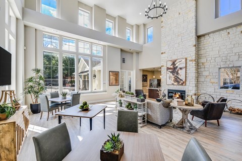 A modern living room with a fireplace and a large window.