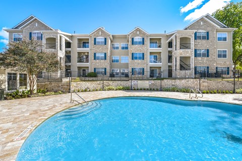 A large apartment complex with a swimming pool in front at Acclaim at South Congress, Austin, 78704