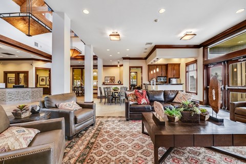 A living room with a brown leather couch and a coffee table.