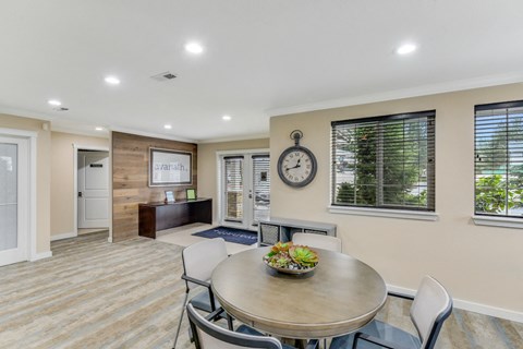 A dining room with a round table and chairs.