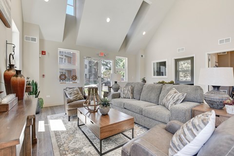 A living room with a grey couch and a coffee table.