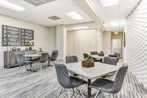 A conference room with a long table surrounded by chairs and a board with names on it. at Academy at Drexel Apartments, Illinois, 60637