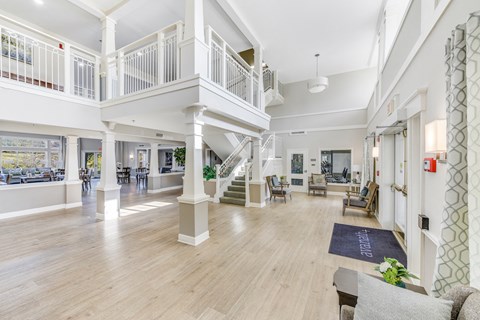 A spacious living room with a staircase and a balcony at Manor at Victoria Park, Temple Hills, MD 20748