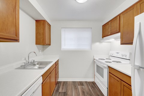 A kitchen with wooden cabinets and white appliances.