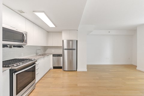 A kitchen with white cabinets and stainless steel appliances.
