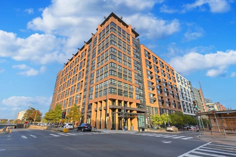 Modern brick apartment building exterior at corner intersection at Community Thumbnail Apartments, Willowbrook, IL 60527
