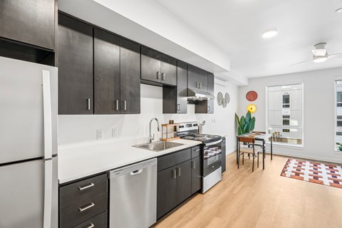 A modern kitchen with dark wood cabinets and white appliances.