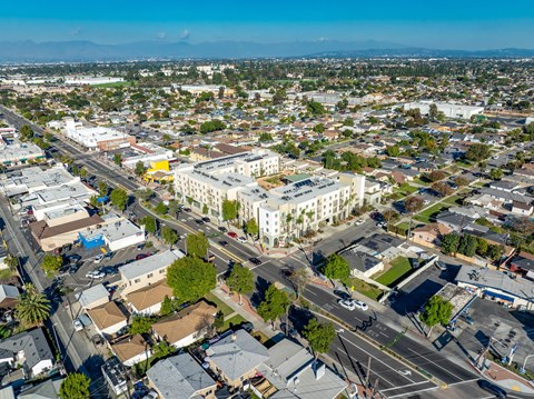 A bird's eye view of a city with a large white building in the center.