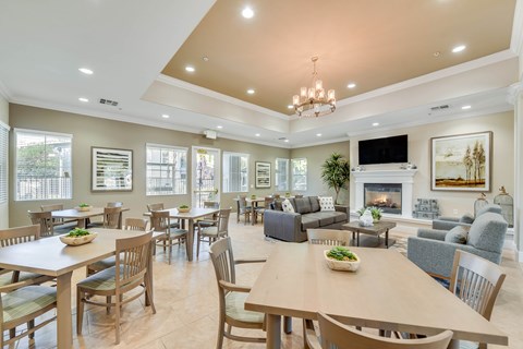A spacious dining room with a large table and chairs.