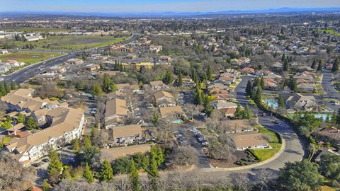 A bird's eye view of a residential neighborhood with houses and trees.