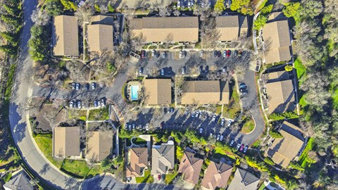 A bird's eye view of a residential area with houses and cars.
