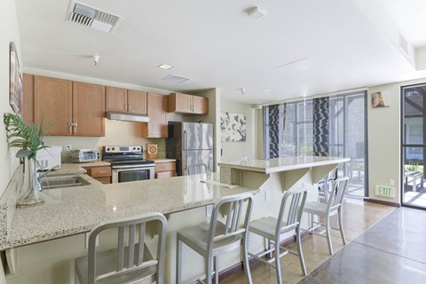 A kitchen with a table and chairs.
