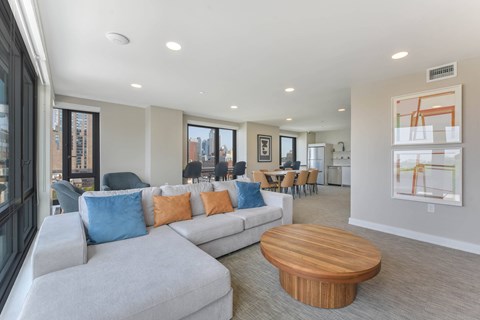 A living room with a grey couch and a wooden coffee table.