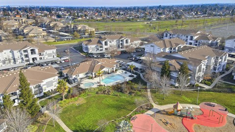 A bird's eye view of a residential area with a swimming pool and playground.