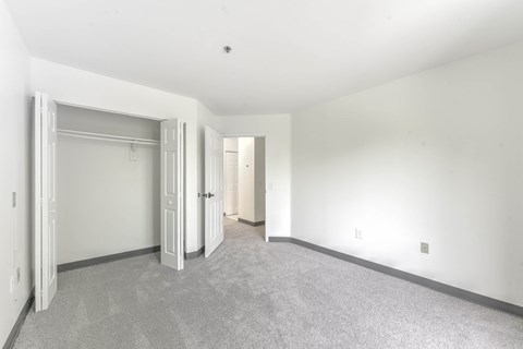 Empty bedroom with closet and carpet at Centennial Court Apartments, Wharton, NJ 7885