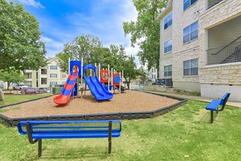 Playground with a blue slide at Acclaim at South Congress, Austin, TX
