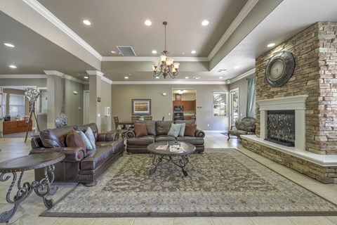 A living room with a fireplace and a chandelier.