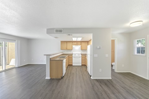 A kitchen with a dishwasher and a refrigerator.