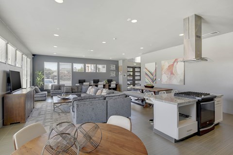 A modern kitchen with a dining table and chairs in the foreground.