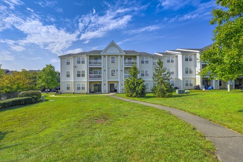 Apartment buildings with green lawn at Acclaim at Ashburn Apartments, Ashburn, Virginia