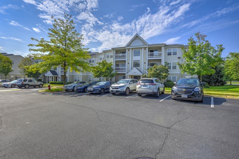 Parking lot with cars and apartment buildings at Acclaim at Ashburn Apartments, Virginia