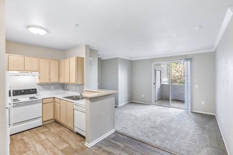 A kitchen with white appliances and wooden cabinets.