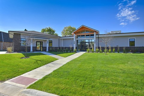 Modern clubhouse exterior with landscaped lawn at Photo Gallery Apartments, Illinois, 60527