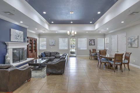 A living room with a fireplace and a dining table set up.