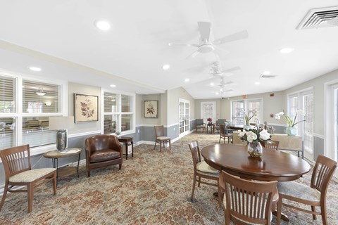 Community room with dining tables and ceiling fans at Victoria Park at Edgewater Apartments, Edgewater
