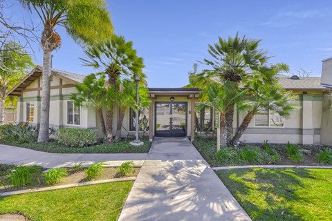 A building with a clear blue sky above it and palm trees in front at Yorba Linda Apartments, Yorba Linda, 92886
