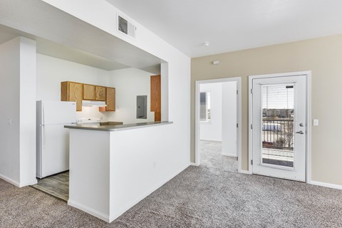 A kitchen area with a white counter and a refrigerator.