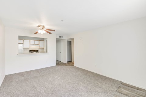 Living room with kitchen pass through and ceiling fan at Woodcreek Terrace Apartments, Roseville, 95747