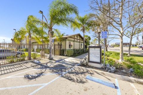 A parking lot with a sign and a building in the background at Yorba Linda Apartments, Yorba Linda, CA 92886