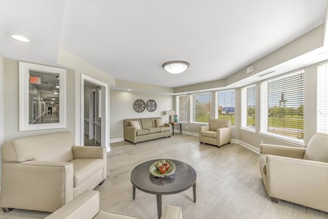 A spacious living room with a dining table and chairs.