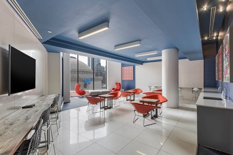A modern dining area with red chairs and a wooden table.