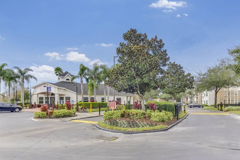 Entrance driveway with landscaped median and office at Acclaim at Conroy Apartments, Florida, 32811