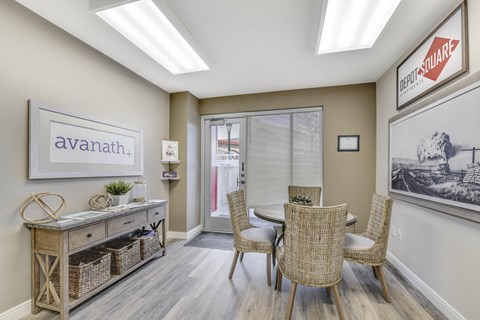 A dining room with a table and chairs.