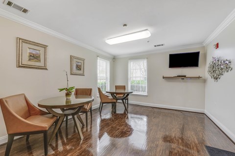 A dining room with a table and chairs.