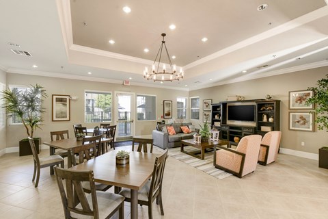 A well-lit, spacious living room with a dining table and chairs.