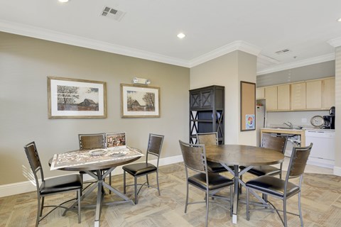 A dining room with a table and chairs.