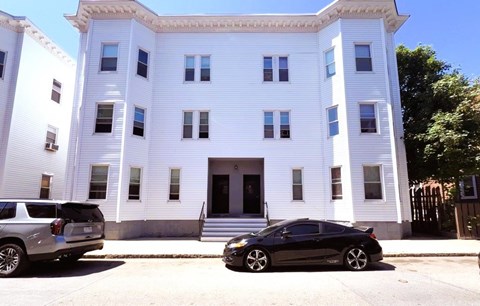 Three story apartment building exterior at Logo Apartments, Roxbury, 02119