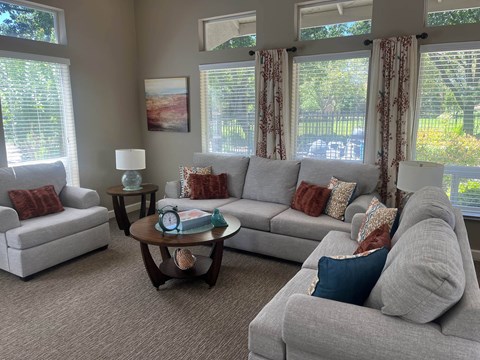 A living room with grey couches and a coffee table.